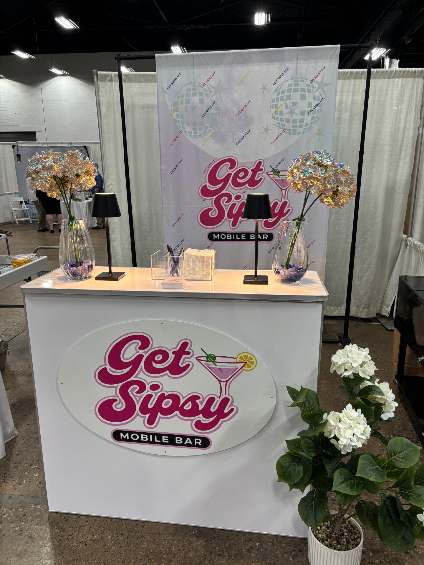 Get Sipsy mobile bar front view with disco backdrop and floral styling