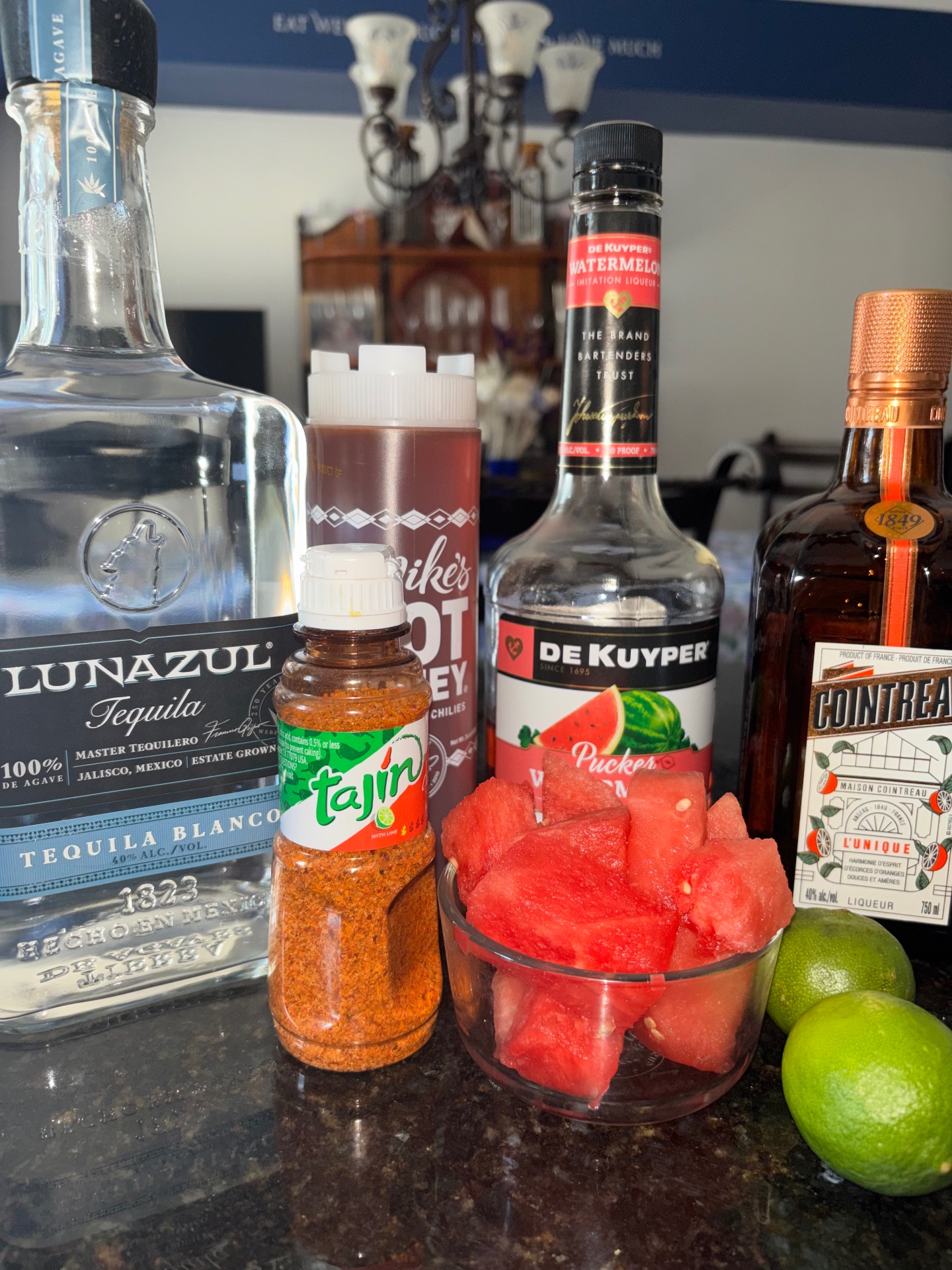 Watermelon margarita ingredients with Lunazul tequila, Cointreau, and fresh limes