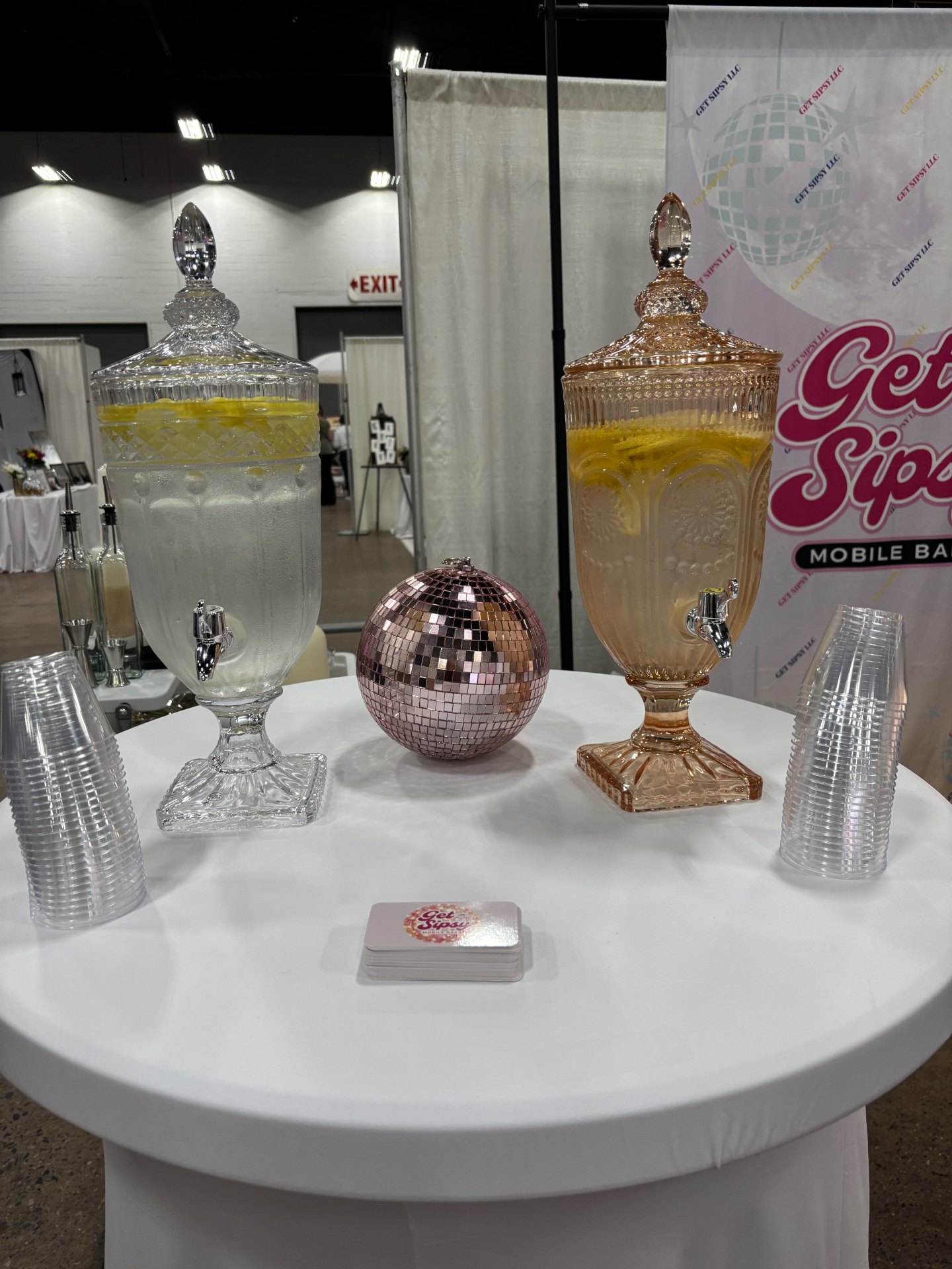 Vintage glass drink dispensers with lemonade and a pink disco ball